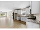 Bright, open kitchen features white cabinets, granite countertops, and stainless steel appliances at 213 Benfield Rd, Kings Mountain, NC 28086