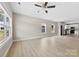 Spacious living room featuring light wood floors, neutral walls, a ceiling fan, and natural light at 213 Benfield Rd, Kings Mountain, NC 28086