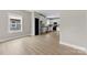 An open-concept living room with light wood floors leading into a kitchen with new stainless appliances at 213 Benfield Rd, Kings Mountain, NC 28086