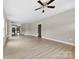 Open-concept living room offers natural light, neutral walls, and sleek flooring leading to the kitchen at 213 Benfield Rd, Kings Mountain, NC 28086