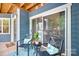 Inviting outdoor balcony features seating, a small table with plant, and sliding door to interior at 2209 Sumner Green Ave # M, Charlotte, NC 28203