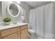 Bright bathroom with patterned tile, a walk-in shower, and modern fixtures at 2209 Sumner Green Ave # M, Charlotte, NC 28203
