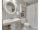 Bright bathroom with a pedestal sink, modern fixtures, and a shower with a curtain at 2209 Sumner Green Ave # M, Charlotte, NC 28203