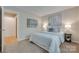 Cozy bedroom featuring two pieces of art and a doorway leading to another room at 2209 Sumner Green Ave # M, Charlotte, NC 28203