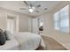 A bright bedroom with a ceiling fan and a view into another room through the open door at 2209 Sumner Green Ave # M, Charlotte, NC 28203