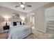Bedroom with attached bathroom and walk-in closet, ceiling fan, neutral tones, and comfy bedding at 2209 Sumner Green Ave # M, Charlotte, NC 28203
