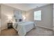Cozy bedroom featuring natural light, neutral walls, and elegant side tables with lamps at 2209 Sumner Green Ave # M, Charlotte, NC 28203