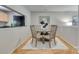 Well-lit dining area with wood table set, adjacent to the kitchen at 2209 Sumner Green Ave # M, Charlotte, NC 28203