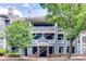 Multi-story building with blue siding, white trim, multiple balconies, and well maintained landscaping at 2209 Sumner Green Ave # M, Charlotte, NC 28203