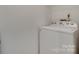 Laundry room with a white washing machine; electrical outlet visible; white walls at 2209 Sumner Green Ave # M, Charlotte, NC 28203