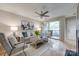 Cozy living room featuring a ceiling fan, fireplace, and sliding glass door to the patio at 2209 Sumner Green Ave # M, Charlotte, NC 28203