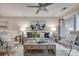 Bright living room with neutral tones, stylish decor, and a ceiling fan at 2209 Sumner Green Ave # M, Charlotte, NC 28203