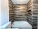Upgraded bathroom showcasing a tub with a shower and tile surround at 2328 Milton Ave, Gastonia, NC 28052
