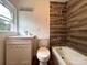 Renovated bathroom featuring a modern vanity and shower with stylish tile at 2328 Milton Ave, Gastonia, NC 28052