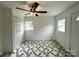 White bedroom featuring a ceiling fan and two windows at 2328 Milton Ave, Gastonia, NC 28052