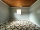 This bedroom features a stained wood ceiling and one window at 2328 Milton Ave, Gastonia, NC 28052