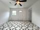 White bedroom featuring a ceiling fan, door, and a window at 2328 Milton Ave, Gastonia, NC 28052