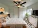 Bright bedroom with neutral tones, ceiling fan, and closet at 2328 Milton Ave, Gastonia, NC 28052