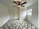 White bedroom featuring a ceiling fan and two closets at 2328 Milton Ave, Gastonia, NC 28052