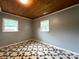 A bedroom features a stained wood ceiling and two windows at 2328 Milton Ave, Gastonia, NC 28052