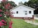 Charming home featuring white siding, a well-maintained lawn, and a beautiful blooming tree in the front yard at 2328 Milton Ave, Gastonia, NC 28052