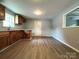Spacious kitchen with wood cabinets, light countertops, and wood-look flooring, awaiting your personal touch at 2328 Milton Ave, Gastonia, NC 28052