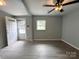 Empty living room featuring a window and a neutral wall color, illuminated by a ceiling fan at 2328 Milton Ave, Gastonia, NC 28052