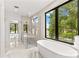 Luxurious bathroom with a soaking tub, a glass shower, and a scenic view at 242 Shoreline Loop, Mooresville, NC 28117