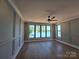 Bedroom with hardwood floors, wainscoting, and windows with a water view at 242 Shoreline Loop, Mooresville, NC 28117