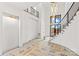 Bright entryway featuring a stunning chandelier and staircase at 242 Shoreline Loop, Mooresville, NC 28117