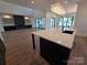 Open floor plan with a kitchen island and modern light fixtures at 242 Shoreline Loop, Mooresville, NC 28117