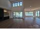 Spacious living room featuring hardwood floors, fireplace, and scenic water views at 242 Shoreline Loop, Mooresville, NC 28117