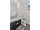 Chic powder room features a modern vanity with bold accents and stylish patterned wallpaper at 242 Shoreline Loop, Mooresville, NC 28117