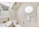 Bright bathroom featuring a built-in vanity, round window, and neutral decor at 2635 Cotton Planter Ln, Charlotte, NC 28270