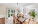 Bright dining room with hardwood floors, chandelier, and large windows offering outdoor views at 2635 Cotton Planter Ln, Charlotte, NC 28270