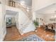 Open-concept foyer with hardwood floors, staircase, and views into the dining and living areas at 2635 Cotton Planter Ln, Charlotte, NC 28270
