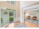 Bright entryway featuring hardwood floors, an open door, and a glimpse into a cozy sitting area at 2635 Cotton Planter Ln, Charlotte, NC 28270