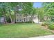 Traditional home featuring manicured lawn, mature trees, and charming curb appeal at 2635 Cotton Planter Ln, Charlotte, NC 28270