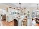 Bright kitchen featuring an island with seating, modern lighting, and hardwood floors at 2635 Cotton Planter Ln, Charlotte, NC 28270