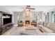 Inviting living room featuring a fireplace, wood floors, and plenty of natural light at 2635 Cotton Planter Ln, Charlotte, NC 28270