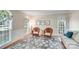 Cozy sitting area with wicker chairs, botanical prints, and lots of natural light at 2635 Cotton Planter Ln, Charlotte, NC 28270