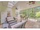 Bright sunroom featuring tile floors, wicker furniture and a view of the backyard at 2635 Cotton Planter Ln, Charlotte, NC 28270