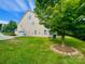Spacious backyard with a lush lawn and mature trees, offering privacy at 282 Fischer Rd, Fort Mill, SC 29175