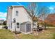 A backyard featuring a well-maintained lawn, storage shed, basketball hoop, and an outdoor seating area at 282 Fischer Rd, Fort Mill, SC 29175