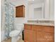 Cozy bathroom features tiled floor, granite countertop vanity, and decorative shower curtain at 282 Fischer Rd, Fort Mill, SC 29175