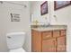 Cozy half-bath with granite counters, framed mirror, and novelty wall decal at 282 Fischer Rd, Fort Mill, SC 29175