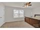 Bedroom features a dark wood bed frame, a ceiling fan, and large window at 282 Fischer Rd, Fort Mill, SC 29175