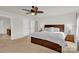 Spacious bedroom with a dark wood bed frame, ceiling fan, and neutral carpet at 282 Fischer Rd, Fort Mill, SC 29175