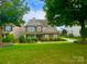 Charming two-story home featuring a well-manicured lawn and beautiful landscaping at 282 Fischer Rd, Fort Mill, SC 29175