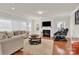 Bright living room with a fireplace, plush seating, and hardwood floors, perfect for relaxing and entertaining at 282 Fischer Rd, Fort Mill, SC 29175